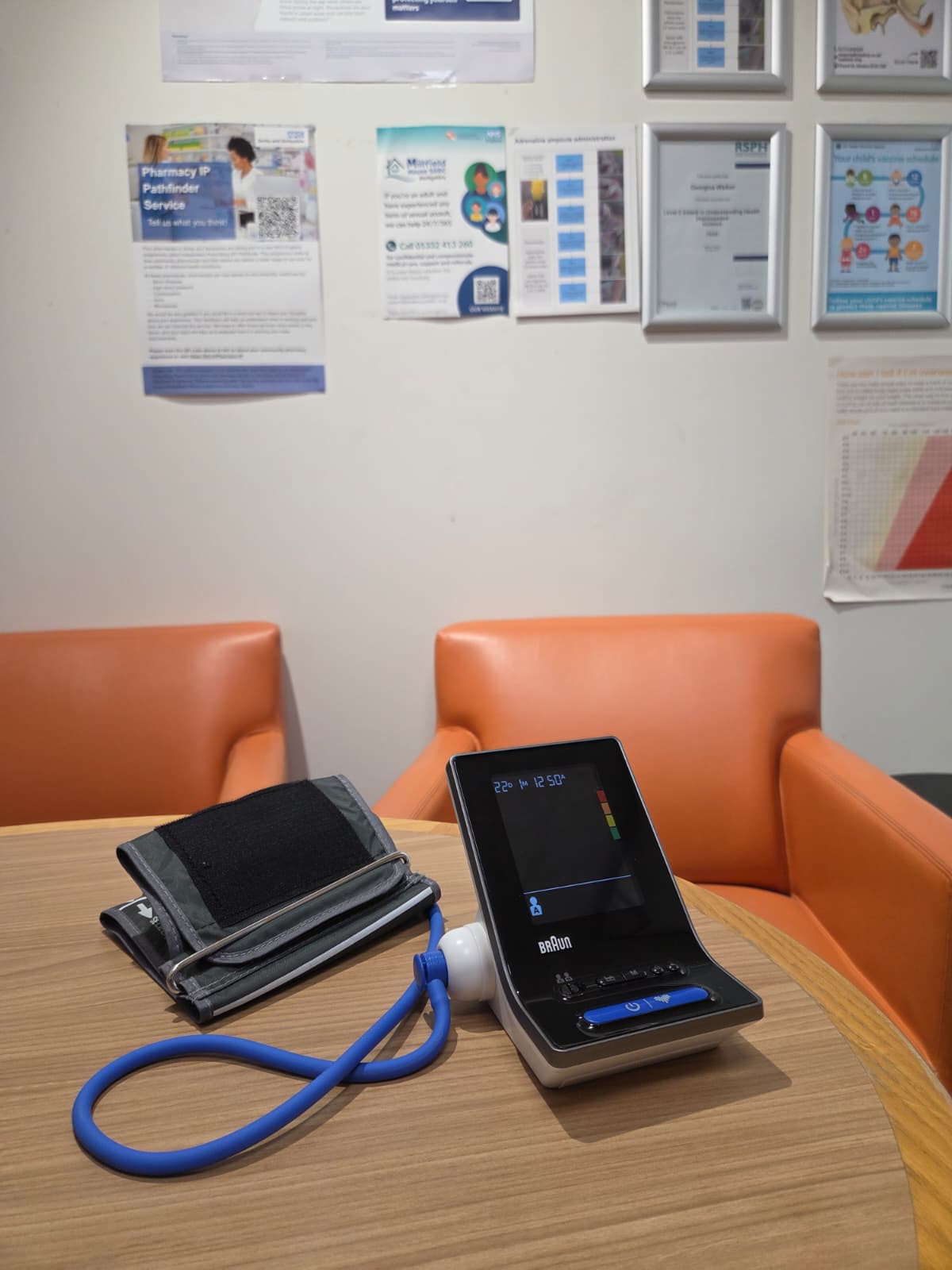 A blood pressure monitor and arm cuff on the table in the consultation area at Medicine Stop, Alfreton.