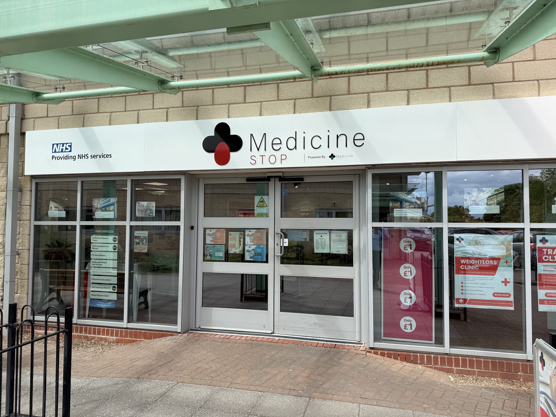 The Medicine Stop pharmacy shopfront on Church Street, Alfreton, with NHS signage and entrance doors.