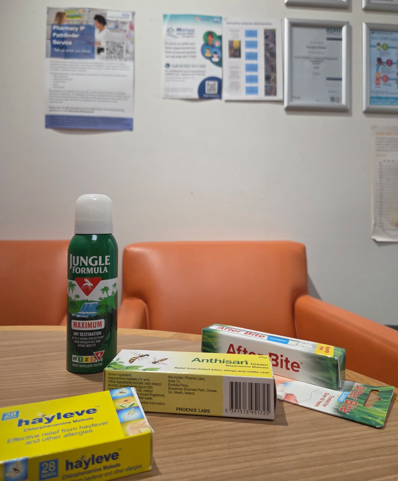 Insect-bite remedies on a table at Medicine Stop: repellent spray, soothing creams and antihistamine tablets.